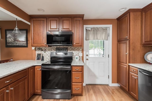 33 Cranberry Rd, Whitman, MA 02382 - kitchen featuring appliances with stainless steel finishes, light wood-style flooring, brown cabinetry, and backsplash