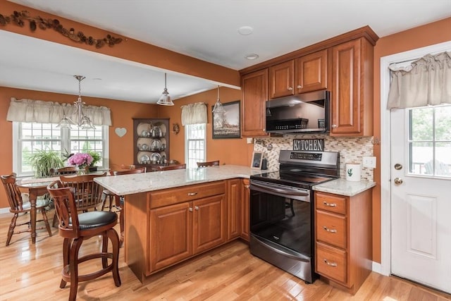 33 Cranberry Rd, Whitman, MA 02382 - kitchen with stainless steel electric stove, brown cabinetry, a peninsula, light stone counters, and beamed ceiling
