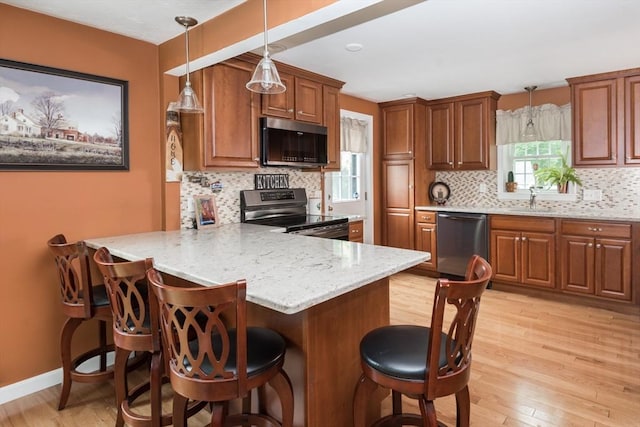33 Cranberry Rd, Whitman, MA 02382 - kitchen with stainless steel appliances, a peninsula, a breakfast bar, and a sink