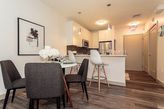 dining area featuring dark hardwood / wood-style floors