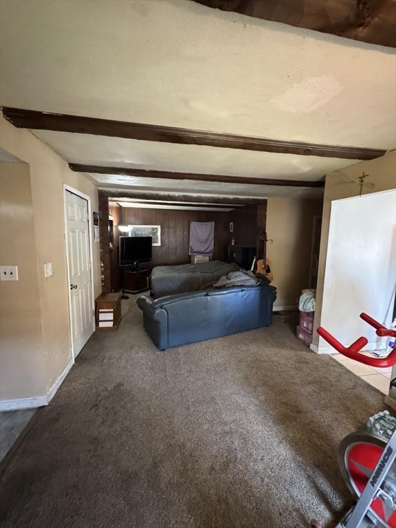 817 Middle St, Weymouth, MA 02188 - carpeted living room featuring beam ceiling and baseboards