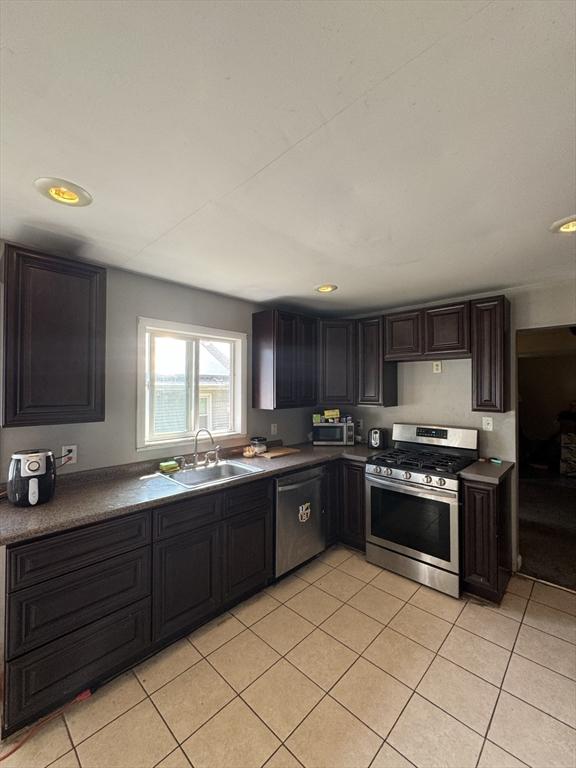 817 Middle St, Weymouth, MA 02188 - kitchen with appliances with stainless steel finishes, light tile patterned flooring, dark countertops, and recessed lighting