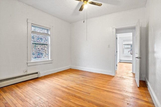 unfurnished room with a baseboard radiator, ornamental molding, light wood finished floors, ceiling fan, and healthy amount of natural light