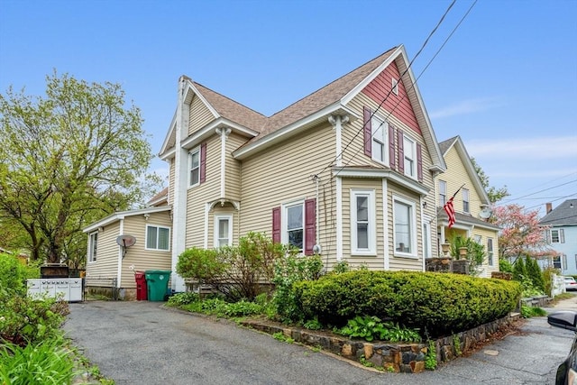 view of property exterior featuring roof with shingles