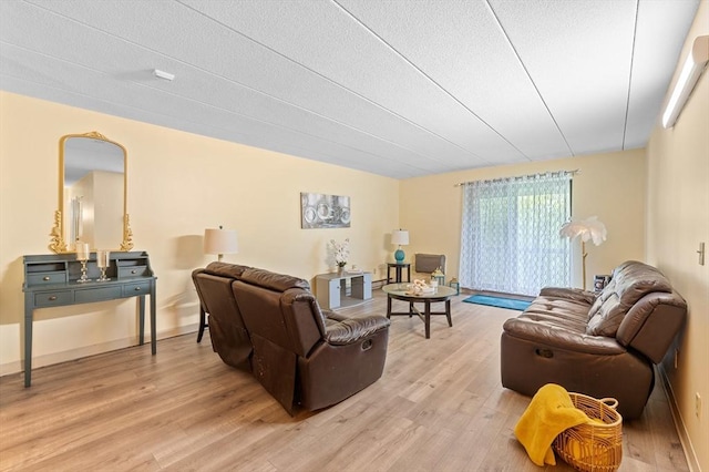 65 Commons Dr Unit 603, Shrewsbury, MA 01545 - living area featuring light wood finished floors and a textured ceiling