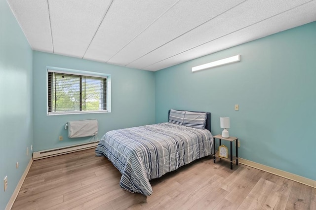 65 Commons Dr Unit 603, Shrewsbury, MA 01545 - bedroom with a baseboard heating unit and wood finished floors