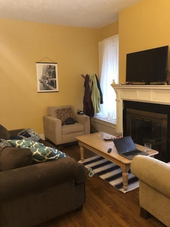 1269 Commonwealth Ave Unit 2, Boston, MA 02134 - living area with wood finished floors and a glass covered fireplace