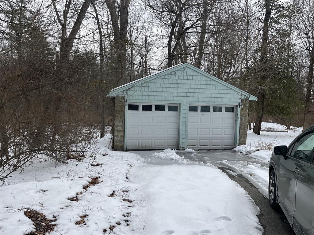 snow covered garage with a garage