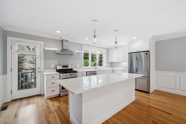 33 Oval Rd Unit 2, Quincy, MA 02170 - kitchen with stainless steel appliances, wall chimney range hood, light countertops, white cabinetry, and a kitchen island