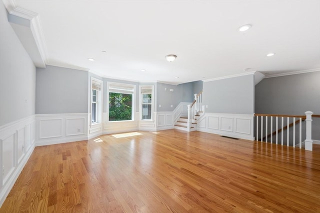 33 Oval Rd Unit 2, Quincy, MA 02170 - unfurnished room featuring crown molding, a decorative wall, a wainscoted wall, light wood-style floors, and recessed lighting
