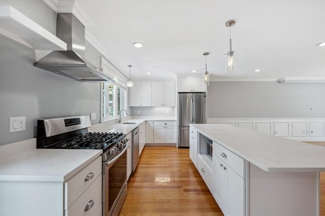 33 Oval Rd Unit 2, Quincy, MA 02170 - kitchen featuring appliances with stainless steel finishes, wall chimney exhaust hood, a sink, a kitchen island, and crown molding