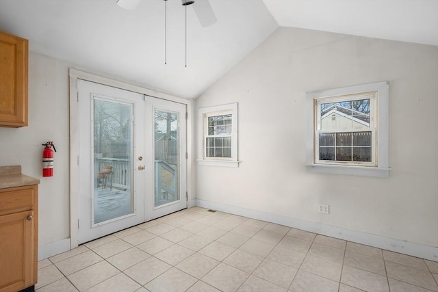 interior space featuring a ceiling fan, lofted ceiling, plenty of natural light, and french doors