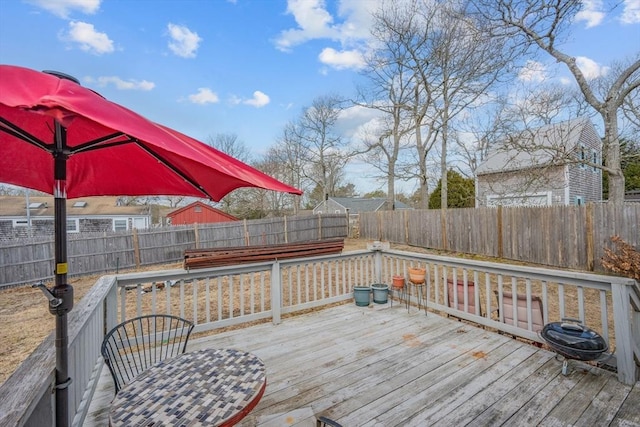 wooden terrace featuring a fenced backyard