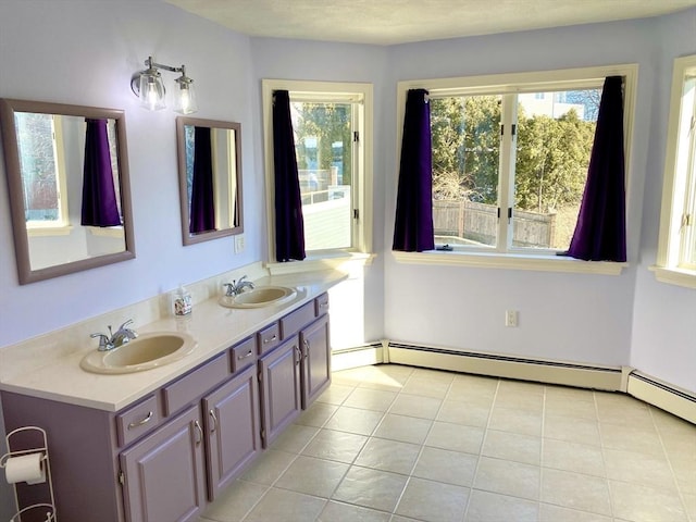 bathroom featuring vanity, a baseboard heating unit, and tile patterned floors