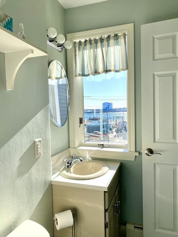 bathroom featuring a baseboard radiator and vanity