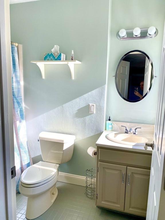 bathroom with tile patterned floors, toilet, and vanity