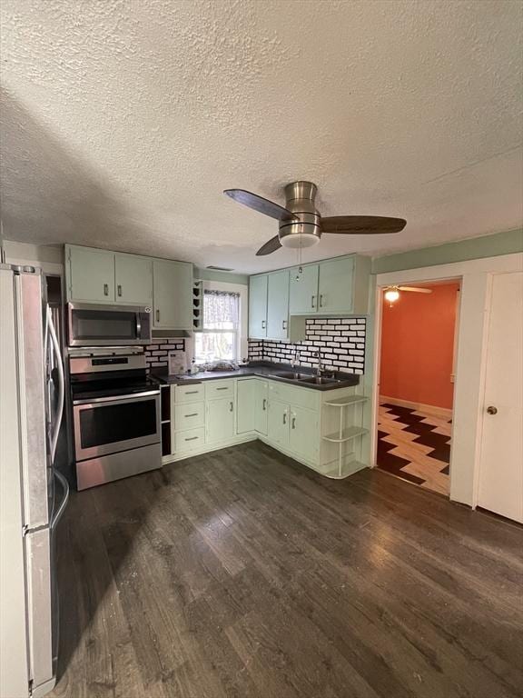 kitchen featuring tasteful backsplash, green cabinetry, and appliances with stainless steel finishes