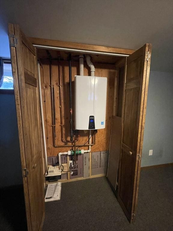 utility room featuring water heater