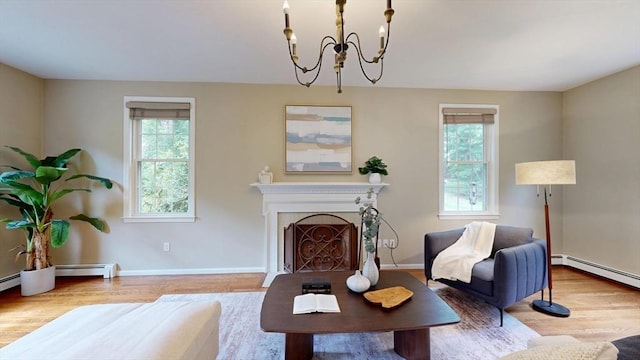 1 Ridgeway Rd, North Reading, MA 01864 - living room with wood finished floors, a baseboard radiator, a chandelier, and a fireplace