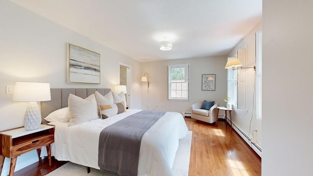 1 Ridgeway Rd, North Reading, MA 01864 - bedroom featuring a baseboard heating unit and wood finished floors