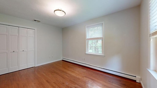 1 Ridgeway Rd, North Reading, MA 01864 - unfurnished bedroom with baseboard heating, wood finished floors, and a closet