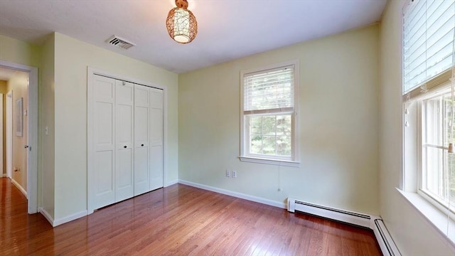 1 Ridgeway Rd, North Reading, MA 01864 - unfurnished bedroom featuring wood finished floors, a closet, and a baseboard radiator