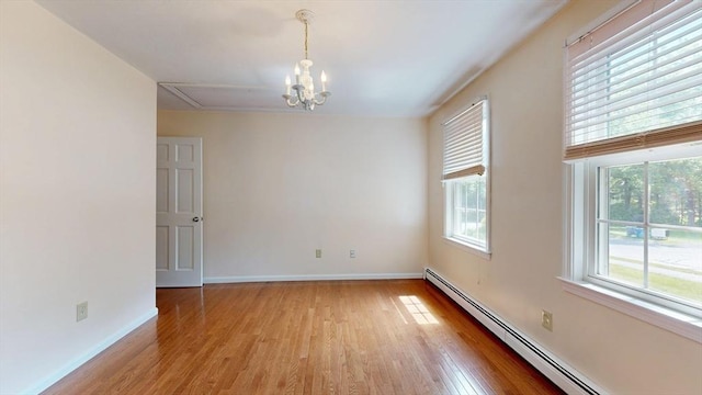 1 Ridgeway Rd, North Reading, MA 01864 - spare room with a baseboard radiator, plenty of natural light, light wood finished floors, and a chandelier