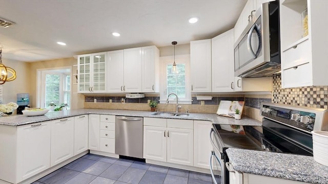 1 Ridgeway Rd, North Reading, MA 01864 - kitchen with appliances with stainless steel finishes, a peninsula, white cabinets, backsplash, and hanging light fixtures