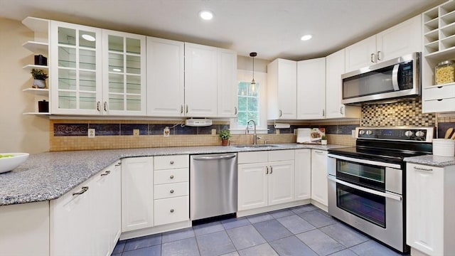 1 Ridgeway Rd, North Reading, MA 01864 - kitchen featuring stainless steel appliances, open shelves, white cabinetry, light tile patterned floors, and light stone countertops