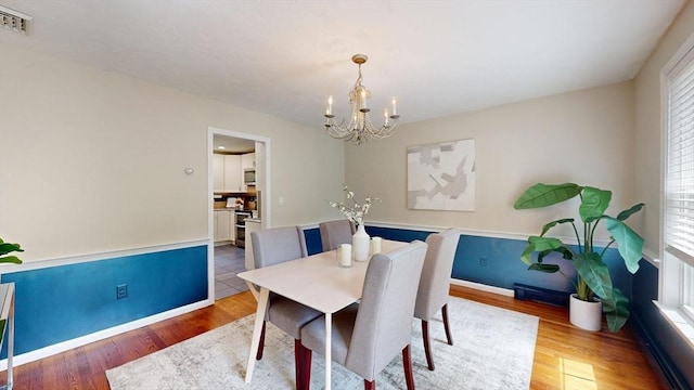1 Ridgeway Rd, North Reading, MA 01864 - dining area featuring a chandelier, healthy amount of natural light, and wood finished floors