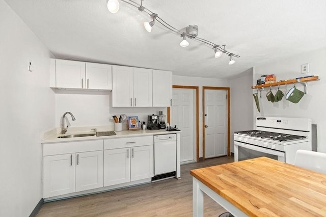 42 Carolina Ave, Boston, MA 02130 - kitchen featuring white appliances, a sink, white cabinets, light countertops, and light wood finished floors