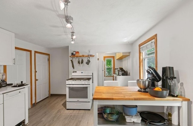 42 Carolina Ave, Boston, MA 02130 - kitchen featuring white appliances, light wood finished floors, white cabinetry, and a textured ceiling