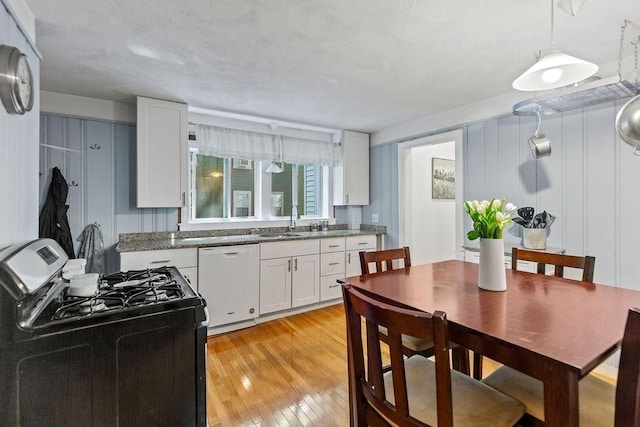 42 Carolina Ave, Boston, MA 02130 - kitchen with black gas stove, dishwasher, white cabinetry, a sink, and light wood-type flooring