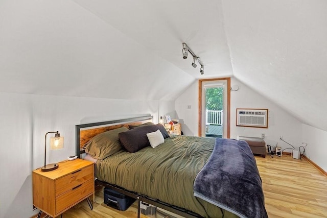 42 Carolina Ave, Boston, MA 02130 - bedroom featuring access to exterior, a wall mounted AC, lofted ceiling, wood finished floors, and rail lighting