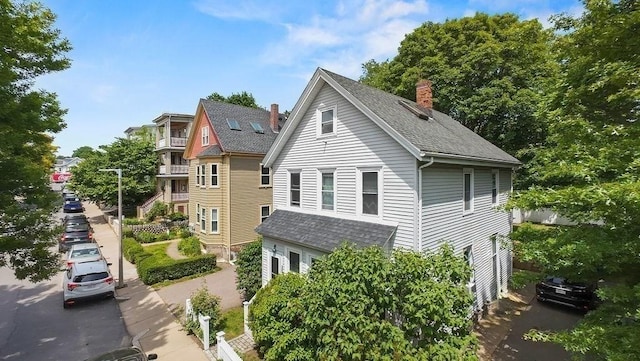 42 Carolina Ave, Boston, MA 02130 - view of home's exterior featuring a chimney and a shingled roof