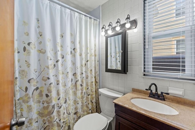 42 Carolina Ave, Boston, MA 02130 - full bathroom featuring tile walls, toilet, vanity, tasteful backsplash, and a shower with curtain