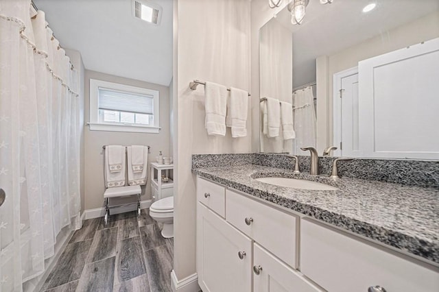 bathroom with vanity and toilet