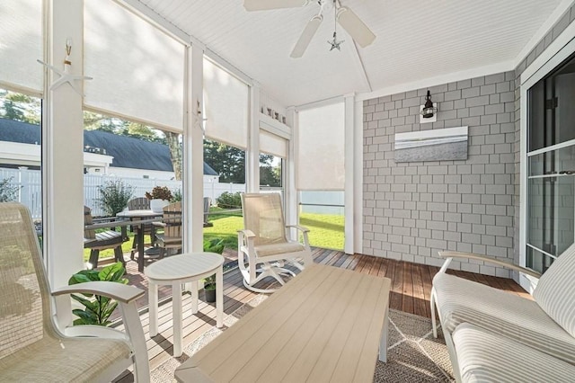 sunroom / solarium featuring ceiling fan and plenty of natural light