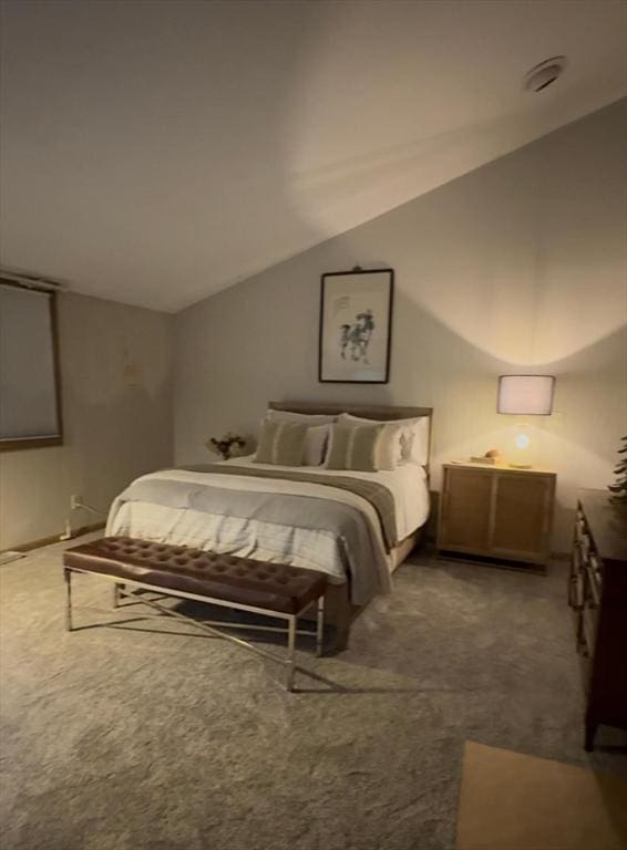 carpeted bedroom featuring lofted ceiling