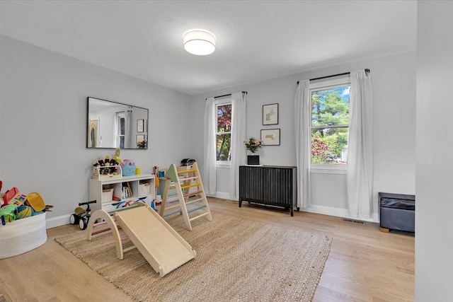 playroom featuring wood finished floors and baseboards
