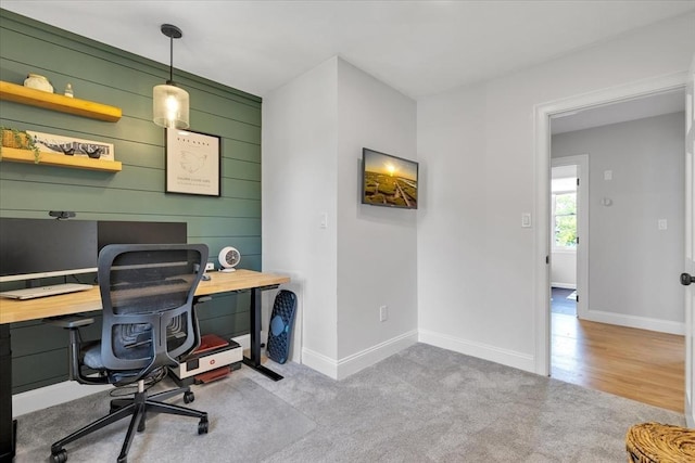 office area featuring baseboards and carpet