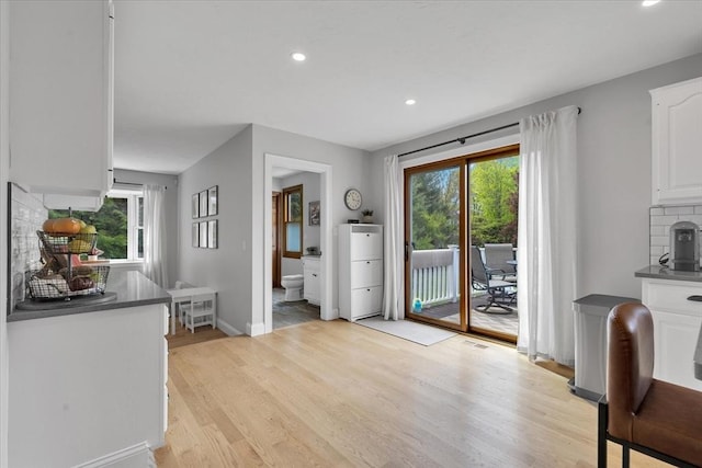 entryway with light wood finished floors, recessed lighting, and baseboards