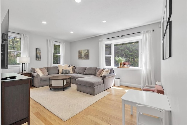 living area featuring recessed lighting, wood finished floors, and baseboards