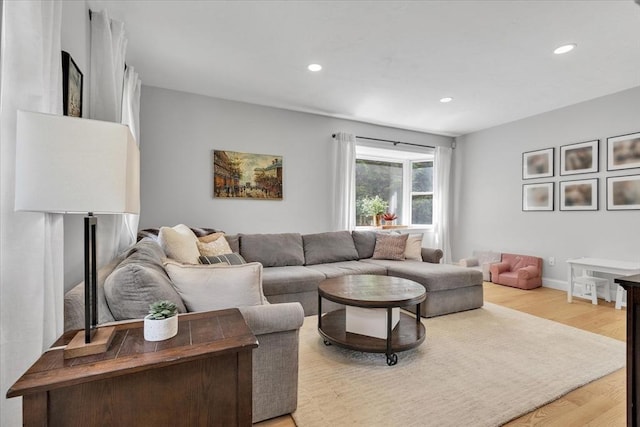 living room featuring light wood-style flooring and recessed lighting