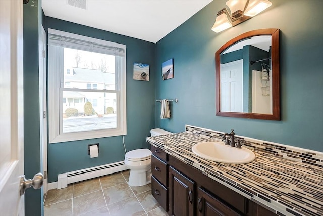 bathroom featuring tile patterned flooring, toilet, vanity, baseboard heating, and tasteful backsplash