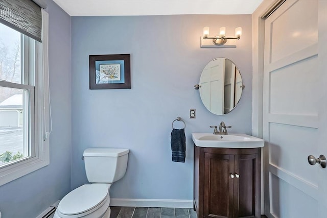 half bath featuring a baseboard radiator, plenty of natural light, toilet, and baseboards