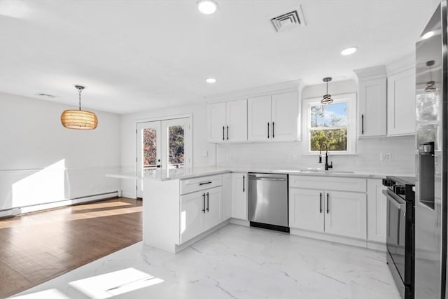 kitchen with stainless steel appliances, white cabinetry, pendant lighting, and kitchen peninsula