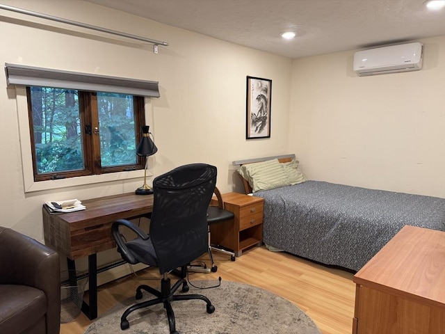 52 Nourse St, Westborough, MA 01581 - bedroom featuring an AC wall unit, light wood-type flooring, a desk, a baseboard heating unit, and recessed lighting