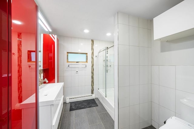 52 Nourse St, Westborough, MA 01581 - full bath featuring tile walls, a baseboard radiator, vanity, tile patterned flooring, and shower / bath combination with glass door