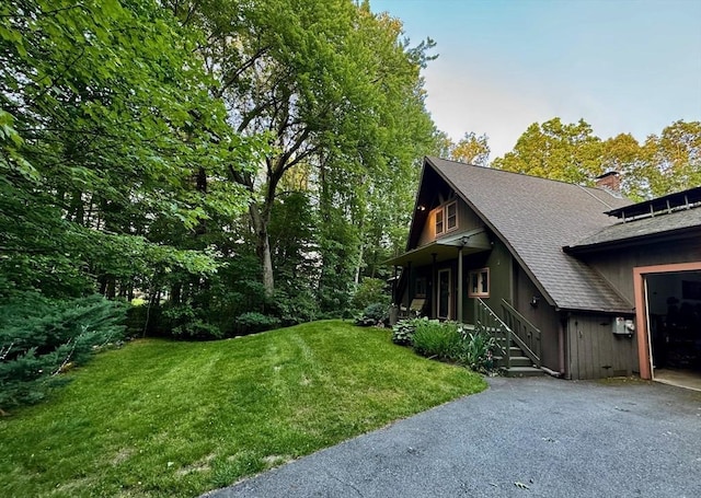 52 Nourse St, Westborough, MA 01581 - view of home's exterior with roof with shingles, a yard, driveway, and a chimney
